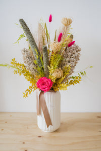 dried flowers and pampas grass arranged in stone vase 
