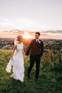 Bride and groom holding hands , sunset in Lydgate